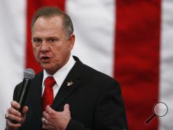  FILE- In this Dec. 11, 2017, file photo, U.S. Senate candidate Roy Moore speaks at a campaign rally in Midland City, Ala. Moore is telling supporters “the battle is not over” in Alabama’s Senate race as he asks for campaign donations and any reports of voting irregularities. Moore in a Friday, Dec. 15, fundraising email asked supporters to contribute to his “election integrity fund” and tell them of any problems at the polls. (AP Photo/Brynn Anderson, File)