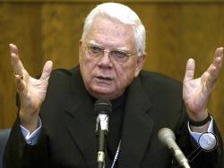 FILE - In this Aug. 2, 2002 file photo, Cardinal Bernard Law, of the Boston archdiocese of the Roman Catholic Church, testifies in Suffolk Superior Court in Boston. Law was answering questions about his knowledge and handling of the Father John Geoghan child sex abuse case. An official with the Catholic Church said Tuesday, Dec. 19, 2017, that Cardinal Bernard Law, the disgraced former archbishop of Boston, has died at 86. Law recently had been hospitalized in Rome. (George Martell/Boston Herald via AP, Po