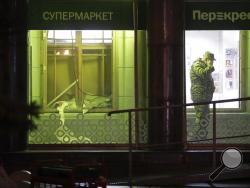 An investigator speaks on the phone inside a supermarket, after an explosion in St.Petersburg, Russia, Wednesday, Dec. 27, 2017. Russian officials say at least 10 people have been injured by an explosion at a supermarket in St. Petersburg. (AP Photo/Dmitri Lovetsky)
