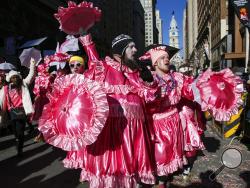 Members of the MGK Outsiders N.Y.B parade on Broad Street during the Mummers Parade in Philadelphia, Monday, Jan. 1, 2018. Thousands of marchers have braved bone-chilling temperatures and wind chills to take part in Philadelphia's annual parade, the oldest continuous folk parade in the country. (Jessica Griffin/The Philadelphia Inquirer via AP)