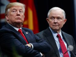 FILE - In this Dec. 15, 2017, file photo, President Donald Trump sits with Attorney General Jeff Sessions during the FBI National Academy graduation ceremony in Quantico, Va. Trump’s White House counsel personally lobbied Attorney General Jeff Sessions to not recuse himself from the Justice Department’s investigation into potential ties between Russia and the Trump campaign. (AP Photo/Evan Vucci, File)