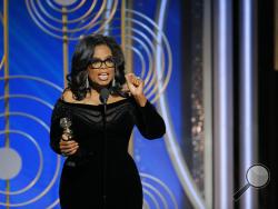 This image released by NBC shows Oprah Winfrey accepting the Cecil B. DeMille Award at the 75th Annual Golden Globe Awards in Beverly Hills, Calif., on Sunday, Jan. 7, 2018. (Paul Drinkwater/NBC via AP)