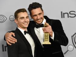 FILE - In this Jan. 7, 2018, file photo, Dave Franco, left, poses with James Franco, winner of the award for best performance by an actor in a motion picture - musical or comedy for "The Disaster Artist," at the InStyle and Warner Bros. Golden Globes afterparty in Beverly Hills, Calif. The New York Times has canceled a public event with James Franco days after the Golden Globe winner was accused of sexual misconduct. The TimesTalk event scheduled for Wednesday, Jan. 10, was intended to feature “The Disaster