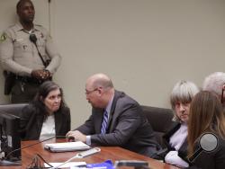 David Allen Turpin, right, and Louise Anna Turpin, left, appear in court for their arraignment in Riverside, Calif., Thursday, Jan. 18, 2018. Prosecutors filed 12 counts of torture, seven counts of dependent adult abuse, six counts of child abuse and 12 counts of false imprisonment against Turpin and his wife, Louise Anna Turpin. Authorities say the abuse left the children malnourished, undersized and with cognitive impairments. (Gina Ferazzi/Los Angeles Times via AP, Pool)