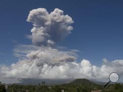 A huge column of ash shoots up to the sky during the eruption of Mayon volcano Monday, Jan. 22, 2018 as seen from Legazpi city, Albay province, around 340 kilometers (200 miles) southeast of Manila, Philippines. The Philippines' most active volcano erupted Monday prompting the Philippine Institute of Volcanology and Seismology to raise the Alert level to 4 from last week's alert level 3. (AP Photo/Earl Recamunda)