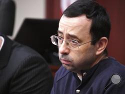 Larry Nassar looks at the gallery in the court during the sixth day of his sentencing hearing Tuesday, Jan. 23, 2018, in Lansing, Mich. Nassar has admitted sexually assaulting athletes when he was employed by Michigan State University and USA Gymnastics, which is the sport's national governing organization and trains Olympians. (Dale G.Young/Detroit News via AP)