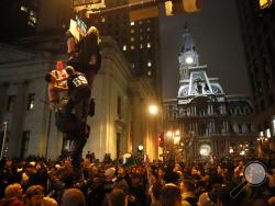 Philadelphia Eagles fans celebrate the team's victory in NFL Super Bowl 52 between the Philadelphia Eagles and the New England Patriots, Sunday, Feb. 4, 2018, in downtown Philadelphia. (AP Photo/Matt Rourke)