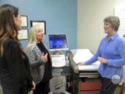 In this Feb. 8, 2018, photo, Blayne Wittig, executive director of Options for Women of California, left, a center in Concord, Calif., Debbie Whittaker, nurse manager, center, and Christine Vatuone, president and CEO of Informed Choices, talk at Informed Choices, a crisis pregnancy center in Grilroy, Calif. (AP Photo/Mark Sherman)