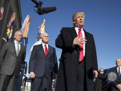 FILE - In this Jan. 18, 2018, file photo, President Donald Trump, joined by Defense Secretary Jim Mattis, left, Vice President Mike Pence, second from left, and White House Chief of Staff John Kelly, right, speaks to the media as he arrives at the Pentagon. When Jennifer Willoughby first stepped forward to tell the story how she was physically, emotionally and psychologically abused by her ex-husband, who had since become a top aide to President Donald Trump, the White House sent a clear message: We don't b