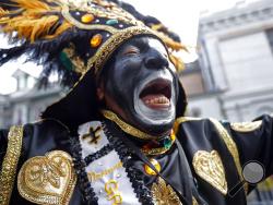 A member of the Krewe of Zulu marches during their parade Mardi Gras day in New Orleans, Tuesday, Feb. 13, 2018. (AP Photo/Gerald Herbert)