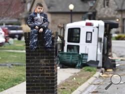 Gio Rodriguez, 8, sits outside his home as his parents clean up debris Sunday morning, Feb. 24, 2018, after a storm hit Saturday in the Farmington subdivision in Clarksville, Tenn. severe thunderstorms swept through the central U.S., spawning a tornado that flattened homes, gale force winds and widespread flooding from the Upper Midwest to Appalachia. (Lacy Atkins/The Tennessean via AP)