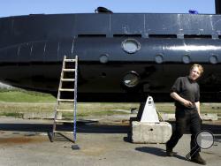 FILE - This April 30, 2008 file photo shows a submarine and its owner Peter Madsen. Peter Madsen stands trial at Copenhagen’s City Court on Thursday March 8, 2018, for the killing of Kim Wall, 30, in his submarine off the usually quiet northern European country. (Niels Hougaard/Ritzau via AP, File)