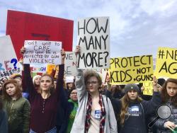 FILE - Students at Roosevelt High School take part in a protest against gun violence Wednesday, March 14, 2018, in Seattle. Politicians in Washington state are joining students who walked out of class to protest against gun violence. It was part of a nationwide school walkout that calls for stricter gun laws following the massacre of 17 people at a Florida high school. (AP Photo/Manuel Valdes)