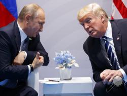 FILE - In this file photo taken on Friday, July 7, 2017, U.S. President Donald Trump, right, meets with Russian President Vladimir Putin at the G-20 Summit in Hamburg, Germany. The Kremlin said Trump called Putin to congratulate him on re-election, and White House press secretary Sarah Huckabee Sanders confirmed that Trump spoke with Putin Tuesday March 20, 2018. (AP Photo/Evan Vucci)