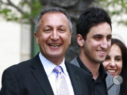 FILE - In this April 21, 2011 file photo shows MGA chief executive Isaac Larian, left, leaves federal court in Santa Ana, Calif., after a victory over Mattel Inc. The CEO of the maker of the pouty Bratz dolls is launching a campaign to salvage some of Toys R Us' U.S. business being liquidated in bankruptcy. (AP Photo/Christine Cotter, File)