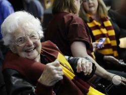 FILE - This March 22, 2018 file photo shows Sister Jean Dolores Schmidt sitting with other Loyola-Chicago fans during the first half of a regional semifinal NCAA college basketball game against Nevada in Atlanta. Sister Jean is depicted in a bobblehead and sales of the figurine have soared to the heavens. She has become a celebrity during the NCAA men’s basketball tournament. As a result, the National Bobblehead Hall of Fame and Museum, in conjunction with Loyola University, last week unveiled a limited edi