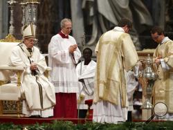 An amphora containing holy oil is placed in front of Pope Francis during a Chrism Mass inside St. Peter's Basilica, at the Vatican, Thursday, March 29, 2018. During the Mass the pontiff blesses a token amount of oil that will be used to administer the sacraments for the year. (AP Photo/Gregorio Borgia)