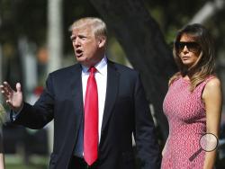 President Donald Trump stops to speak to members of the media as he arrives for Easter services with first lady Melania Trump at Episcopal Church of Bethesda-by-the-Sea in Palm Beach, Fla., Sunday, April 1, 2018. (AP Photo/Pablo Martinez Monsivais)