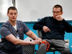 In this March 28, 2018, photo, trauma care specialist Brian Feist and Dr. Richard Sidwell lead a medical training session for teachers and staff at Southeast Polk High School in Pleasant Hill, Iowa. With school shootings a regular occurrence, educators across the country are learning techniques to help victims survive by stemming blood loss. Feist and Sidwell are among those helping educators learn skills in medical training through a nonprofit program, dubbed Stop the Bleed. (AP Photo/Charlie Neibergall)