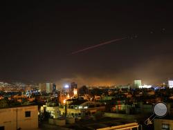 Explosions lit up the skies with anti-aircraft fire, over Damascus, the Syrian capital, as the U.S. launches an attack on Syria targeting different parts of the Syrian capital Damascus, Syria, early Saturday, April 14, 2018. Syria's capital has been rocked by loud explosions that lit up the sky with heavy smoke as U.S. President Donald Trump announced airstrikes in retaliation for the country's alleged use of chemical weapons. (AP Photo/Hassan Ammar)