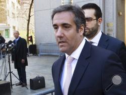 Michael Avenatti, Stormy Daniels' attorney, left, watches as Michael Cohen, center, President Donald Trump's personal attorney, leaves federal court in New York, Thursday, April 26, 2018. President Donald Trump said that Cohen, his personal attorney, represented him "with this crazy Stormy Daniels deal," after previously denying any knowledge of a payment Cohen made to the porn actress who alleges an affair with Trump.(AP Photo/Mary Altaffer)