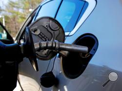 In this April 23, 2018, photo, a car is filled with gasoline at a station in Windham, N.H. Crude oil prices are at the highest level in more than three years and expected to climb higher, pushing up gasoline prices along the way. (AP Photo/Charles Krupa)