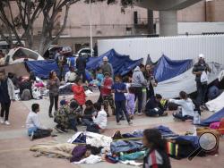 Migrants wait for access to request asylum in the US, at the El Chaparral port of Entry in Tijuana, Mexico, Monday, April 30, 2018. bout 200 people in a caravan of Central American asylum seekers waited on the Mexican border with San Diego for a second straight day on Monday to turn themselves in to U.S. border inspectors, who said the nation's busiest crossing facility did not have enough space to accommodate them. (AP Photo/Hans-Maximo Musielik)