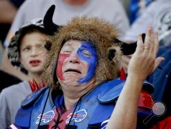 FILE - In this Nov. 19, 2017, file photo, a Buffalo Bills fan reacts during the second half of an NFL football game against the Los Angeles Chargers, in Carson, Calif. In a shot-and-a-beer town where the winters are interminably long, Buffalo sports fans ride things out on the notion of renewal always being just around the corner. (AP Photo/Jae C. Hong, File