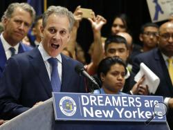 FILE - In this Sept. 6, 2017, file photo, New York Attorney General Eric Schneiderman, at podium, speaks at a news conference in New York, surrounded by beneficiaries of the Deferred Action for Childhood Arrivals program and their supporters. Schneiderman, who had taken on high-profile roles as an advocate for women's issues and an antagonist to the policies of President Donald Trump, announced late Monday, May 7, 2018, that he would be resigning from office hours after four women he was romantically involv