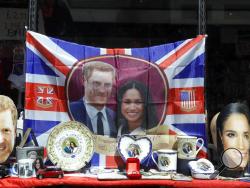 Merchandise is displayed for sale in a shop window in Windsor, England, Monday, May 14, 2018. Preparations are being made in the town ahead of the wedding of Britain's Prince Harry and Meghan Markle that will take place in Windsor on Saturday May 19. (AP Photo/Kirsty Wigglesworth)