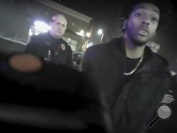 This Jan. 26, 2018 police body-camera footage released by Milwaukee Police Department shows NBA Bucks guard Sterling Brown talks to arresting police officers after being shot by a stun gun in a Walgreens parking lot in Milwaukee. The release comes as city officials who've viewed the videos have expressed concern about how officers conducted themselves. Even leaders of the police department have hinted the video may make them look bad. (Milwaukee Police Department via AP)