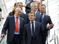 French President Emmanuel Macron, right, and Organisation for Economic Co-operation and Development (OECD) Secretary-General Angel Gurria arrive at the OECD ministerial council meeting on "Refounding Multilateralism", in Paris, France, Wednesday, May 30, 2018. Macron warned against trade wars in an impassioned speech about international cooperation Wednesday, two days before the Trump administration decides whether to hit Europe with punishing new tariffs. (Philippe Wojazer/Pool Photo via AP)