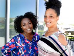 This June 2, 2017, photo, shows Mormon women Tamu Smith, left, and Dr. LaShawn Williams in Lehi, Utah. The Mormon church's celebration Friday night, June 1, 2018, of the 40th anniversary of its reversal of a ban on blacks in the lay priesthood is rekindling discussions about one of the faith's most sensitive topics. Williams, an assistant professor in social work at Utah Valley University, would like an apology. “If we preach repentance, we should definitely embody it,” she said. (Steve Griffin/The Salt Lak