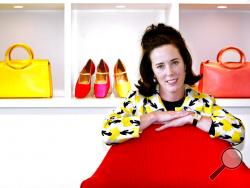 FILE - In this May 13, 2004 file photo, designer Kate Spade poses with handbags and shoes from her next collection in New York. Law enforcement officials say Tuesday, June 5, 2018, that New York fashion designer Kate Spade has been found dead in her apartment in an apparent suicide. (AP Photo/Bebeto Matthews, File)