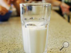 FILE - This June 8, 2007 file photo shows a glass of milk on a table during a family breakfast in Montgomery, Ala. Nearly 20 years ago, about nearly half of high school students said they drank at least one glass of milk a day. But now it’s down to less than a third, according to a survey released by the Centers for Disease Control and Prevention on Thursday, June 14, 2018. (AP Photo/Rob Carr)
