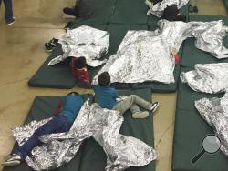 In this photo provided by U.S. Customs and Border Protection, people who've been taken into custody related to cases of illegal entry into the United States, rest in one of the cages at a facility in McAllen, Texas, Sunday, June 17, 2018. (U.S. Customs and Border Protection's Rio Grande Valley Sector via AP)