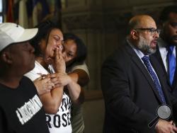 Michelle Kenney, second from left, mother of Antwon Rose Jr., reacts as attorney Fred Rabner addresses reporters at the Allegheny County Courthouse in Pittsburgh, Wednesday, June 27, 2018. At left is Antwon Rose, father of Antwon Jr. Michael Rosfeld, a white police officer, was charged Wednesday with homicide in the shooting of Antwon Rose Jr., an unarmed black teenager who was hit in the back while fleeing a traffic stop. (Harrison Jones/Pittsburgh Post-Gazette via AP)