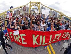 FILE – In this June 22, 2018, file photo, demonstrators protesting the fatal police shooting of Antwon Rose Jr. cross the Roberto Clemente Bridge during an evening rush hour march that began in downtown Pittsburgh. The fatal police shooting of Rose as he fled during a traffic stop on June 19, is the first in the Pittsburgh area in the Black Lives Matter era, and it is galvanizing residents who say they’ve been frustrated for too long. (AP Photo/Gene J. Puskar, File)