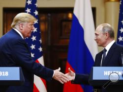 U.S. President Donald Trump shakes hand with Russian President Vladimir Putin at the end of the press conference after their meeting at the Presidential Palace in Helsinki, Finland, Monday, July 16, 2018. (AP Photo/Alexander Zemlianichenko)