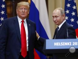 U.S. President Donald Trump, left, and Russian President Vladimir Putin leave after a press conference after their meeting at the Presidential Palace in Helsinki, Finland, Monday, July 16, 2018. (AP Photo/Alexander Zemlianichenko)