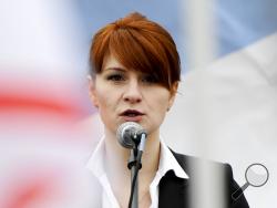 In this photo taken on Sunday, April 21, 2013, Maria Butina, leader of a pro-gun organization in Russia, speaks to a crowd during a rally in support of legalizing the possession of handguns in Moscow, Russia. Butina, a 29-year-old gun-rights activist, served as a covert Russian agent while living in Washington, gathering intelligence on American officials and political organizations and working to establish back-channel lines of communications for the Kremlin, federal prosecutors charged Monday, July 16, 20