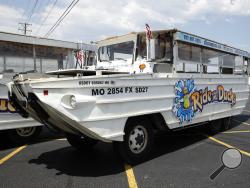 A duck boat sits idle in the parking lot of Ride the Ducks, an amphibious tour operator in Branson, Mo. Friday, July 20, 2018. The amphibious vehicle is similar to one of the company's boats that capsized the day before on Table Rock Lake resulting in 17 deaths. (AP Photo/Charlie Riedel)