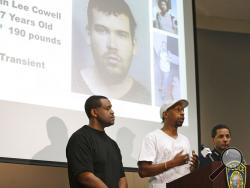Daryle Allums, center, speaks on behalf of the Stop Killing Our Kids movement, about the stabbing of his goddaughter at a press conference Monday, July 23, 2018 in Oakland, Calif., as Bay Area Rapid Transit Police Chief Carlos Rojas, right, and Daryle Muhammad, left, listen. The suspect in the stabbing, John Lee Cowell, 27, is seen projected in the background. A man fatally stabbed an 18-year-old woman in the neck and wounded her sister as they exited a train at a Northern California subway station in what 