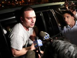 Pablo Villavicencio leans out of an SUV while talking to reporters after being released from the Hudson County Correctional Facility, Tuesday, July 24, 2018, in Kearny, N.J. A judge on Tuesday ordered the immediate release of Villavicencio, an Ecuadorean immigrant who was being held at the facility for deportation after he delivered pizza to a Brooklyn Army installation. U.S. District Judge Paul Crotty said Villavicencio can remain in the United States while he exhausts his right to try to gain legal status