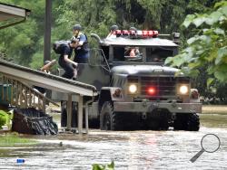 Firefighters from Wrightsville Fire Company use a five ton truck to evacuate residents from homes along flooded Drager Road in Columbia, Pa., Wednesday July 25, 2018. Days of drenching rains are closing roads, sending creeks and streams over their banks and causing businesses and to shut down in central Pennsylvania. (Blaine Shahan/LNP via AP) Firefighters from Wrightsville Fire Company use a five ton truck to evacuate residents from homes along flooded Drager Road in Columbia, Pa., Wednesday July 25, 2018. Days of drenching rains are closing roads, sending creeks and streams over their banks and causing businesses and to shut down in central Pennsylvania. (Blaine Shahan/LNP via AP)