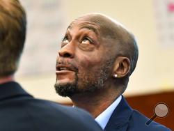 FILE - In this July, 9, 2018, file photo, plaintiff DeWayne Johnson looks up during a brief break as the Monsanto trial in San Francisco. Monsanto is being accused of hiding the dangers of its popular Roundup products. A San Francisco jury on Friday, Aug. 10, 2018, ordered agribusiness giant Monsanto to pay $289 million to a former school groundskeeper dying of cancer, saying the company's popular Roundup weed killer contributed to his disease. The lawsuit brought by Johnson was the first to go to trial amo