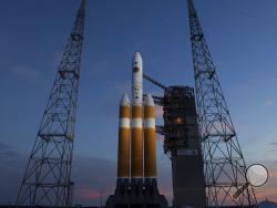 A Delta IV rocket stands ready for launch at complex 37 at the Kennedy Space Center, Friday, Aug. 10, 2018, in Cape Canaveral, Fla. The Parker Solar Probe, scheduled for lift off early Saturday morning, is protected by a first-of-its-kind heat shield and other innovative technologies that will provide unprecedented information about our Sun. (AP Photo/John Raoux)