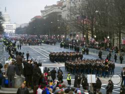 FILE - In this Jan. 20, 2017, file photo, military units participate in the inaugural parade from the Capitol to the White House in Washington, Friday, Jan. 20, 2017. A U.S. official says the 2018 Veterans Day military parade ordered up by President Donald Trump would cost about $92 million _ more than three times the maximum initial estimate. (AP Photo/Cliff Owen, File)