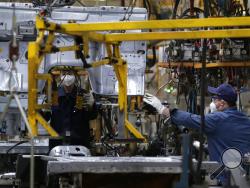 Workers assemble the BAIC Jeep chassis frames at the Chinese automaker BAIC ORU assembly plant in Beijing, Wednesday, Aug. 29, 2018. Their tariff war with the U.S. grabs headlines, but China faces bigger economic challenges than U.S. President Donald Trump. Communist leaders who are trying to nurture more sustainable growth in the world’s No. 2 economy clamped down on bank lending to rein in surging debt. (AP Photo/Andy Wong)