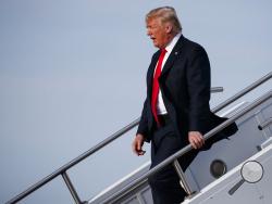 President Donald Trump walks off Air Force One after arriving at Evansville Regional Airport, Thursday, Aug. 30, 2018, in Evansville, Ind. (AP Photo/Evan Vucci)